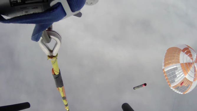 The parachute with a Rocket Lab booster was caught by a helicopter after this photo. It was the first time the company fully tested its recovery method after launching on May 2, 2022 from New Zealand. (Image: Rocket Lab)