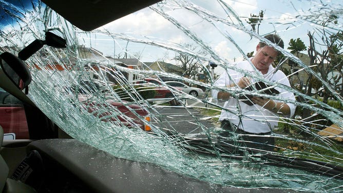 Insurance agent evaluating storm damage 2004