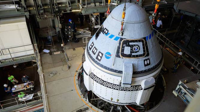 The Boeing CST-100 Starliner spacecraft is lifted at the Vertical Integration Facility at Space Launch Complex-41 at Cape Canaveral Space Force Station in Florida on May 4, 2022, ahead of its second Orbital Flight Test (OFT-2) to the International Space Station for NASA's Commercial Crew Program. Credits: NASA/Frank Michaux