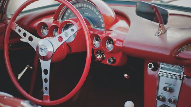 Red steering wheel and dash of a car.