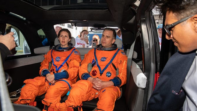 Technicians from Johnson Space Center, dressed in flight suits, secure themselves inside a prototype of a crew transportation vehicle (CTV) for Artemis crewed missions outside the Neil Armstrong Operations and Checkout Building at NASA’s Kennedy Space Center in Florida on May 11, 2022. Canoo Technologies Inc., was awarded a contract to design and provide the next generation of CTVs for the Artemis crewed missions. Representatives with Canoo were at the spaceport demonstrating the environmentally friendly fleet of vehicles. Artemis II will be the first Artemis mission flying crew aboard Orion. (Photo credit: NASA/Kim Shiflett)