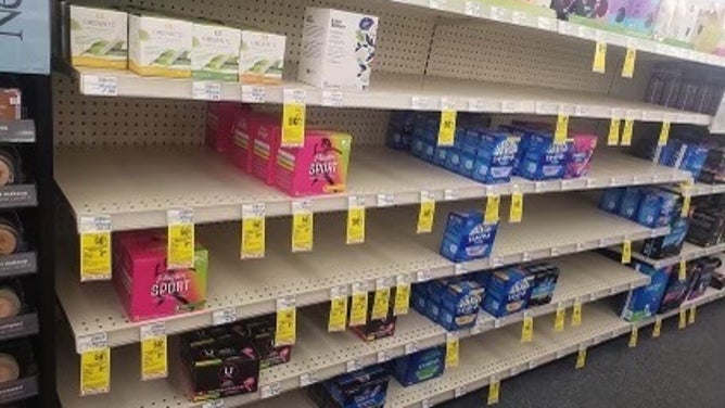Mostly bare shelves of period products at a pharmacy. (Image: Dana Marlowe/I Support The Girls)