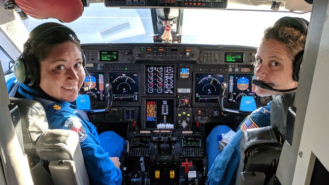 Waddington (left) and CAPT Kristie Twining (right) in the cockpit of NOAA's Gulfstream-IV Hurricane Hunter jet.