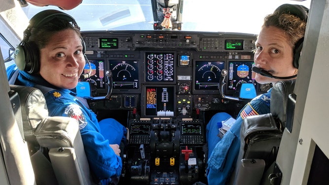 Waddington (left) and CAPT Kristie Twining (right) in the cockpit of NOAA's Gulfstream-IV Hurricane Hunter jet.