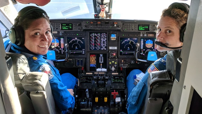Waddington (left) and CAPT Kristie Twining (right) in the cockpit of NOAA's Gulfstream-IV Hurricane Hunter jet.