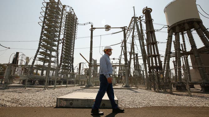 Jeffrey Lamb, Manager of extra high voltage stations for LADWP walks the DC yard at the Sylmar Converter Station, a piece of power grid infrastructure operated by LADWP threatened by Oregon wildfires that almost caused the lights to go out in California on Friday night. The Sylmar Converter Station is the terminus of the Pacific DC Intertie, a giant power line that runs from the Columbia River to Southern California and one of two lines that was affected by the wildfire. Sylmar on Monday, July 12, 2021 in Los Angeles, CA. (Al Seib / Los Angeles Times via Getty Images).