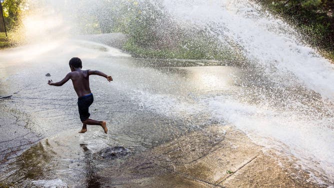 A child plays in water in Bloomington, Indiana.