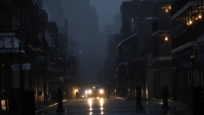 Vehicles drive down Bourbon Street during a city-wide power outage caused by Hurricane Ida in New Orleans, Louisiana, U.S., on Sunday, Aug. 29, 2021. Hurricane Ida barreled into the Louisiana coast on Sunday, packing winds more powerful than Hurricane Katrina and a devastating storm surge that threatens to inundate New Orleans with mass flooding, power outages and destruction. Photographer: Luke Sharrett/Bloomberg via Getty Images