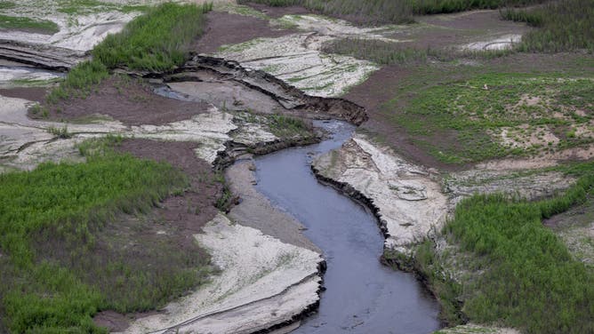 The San Gabriel Reservoir is seen drying up on the second day of summer and after the end of the winter rains, leaving no hope of refilling it this year on June 22, 2022 near Azusa, California. Scientists are warning that the region is in the midst of the worst drought in at least 1,200 years. In anticipation of the debris and sediment flows from the San Gabriel Mountains watersheds that was stripped bare of vegetation by the 115,796 acre Bobcat fire in 2020, the Los Angeles County Flood Control District has begun removing sand and debris that could lead to flooding problems downstream as part of the Bobcat Fire Emergency Reservoir Restoration Projects. (Photo by David McNew/Getty Images)