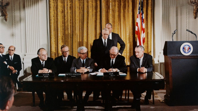 President Lyndon B. Johnson (right) watches the signing of an international treaty banning weapons in outerspace, January 27, 1967 -- the same day three astronauts were killed in a fire aboard an Apollo space craft. (Photo by © CORBIS/Corbis via Getty Images)