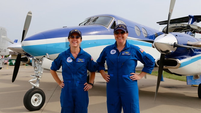 Waddington (right) stands in front of a NOAA King Air 350 CER in Oshkosh, WI in July 2015.
