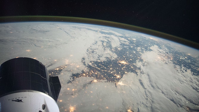 A portion of the SpaceX Cargo Dragon vehicle is pictured as the space station orbited above northern France in September of 2021. (Image: NASA)