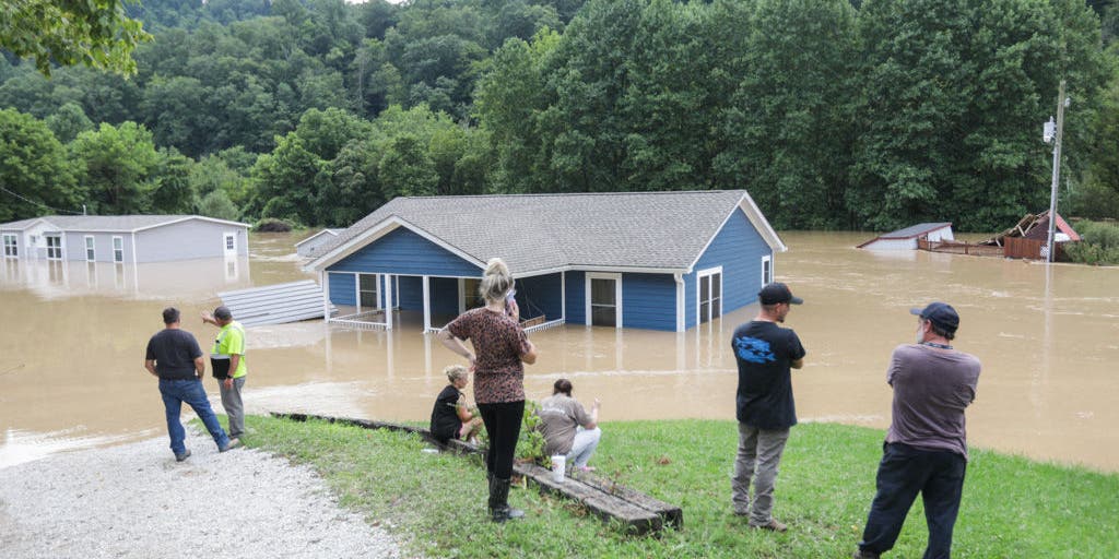 'Houses are floating away' Families trapped as floodwaters tear