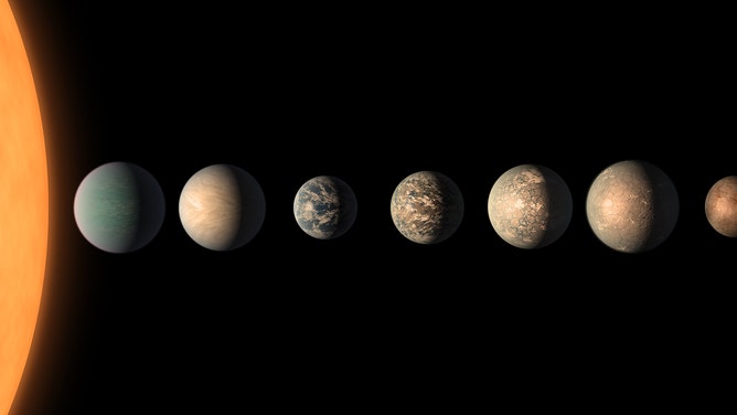 This artist's concept shows what the TRAPPIST-1 planetary system may look like, based on available data about the planets' diameters, masses and distances from the host star
