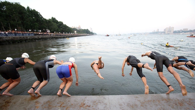 Athletes compete during the New York City Triathlon in the Hudson River on July 18, 2010, in New York City. 