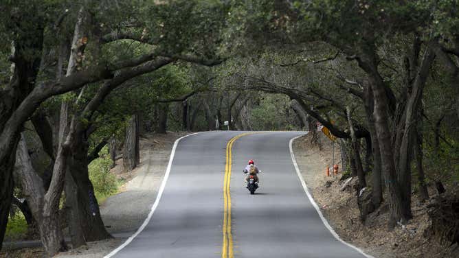 A motorcyclist rides down county highway S19 in California.