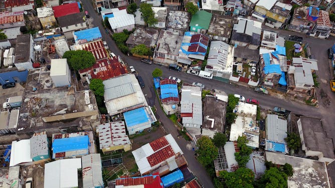 Blue tarps cover rooftops of homes in San Juan Puerto Rico