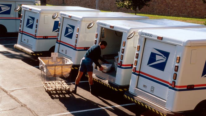 US Post Office mail carrier loading truck