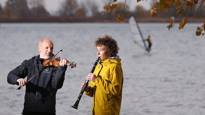 Toronto Symphony Orchestra Sergei Nikonov, Violin and his son Anton on the clarinet play in their favourite spot, the Toronto Windsurfing Club on Cherry Beach in Toronto.
