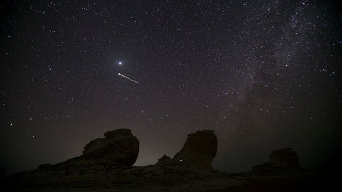 A picture taken on August 13, 2021 shows the Perseid meteor shower over the White Desert north of the Farafra Oasis in the New Valley Governorate.