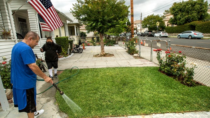 Eddie Vasquez of Lincoln Heights, California, waters his lawn once a week.