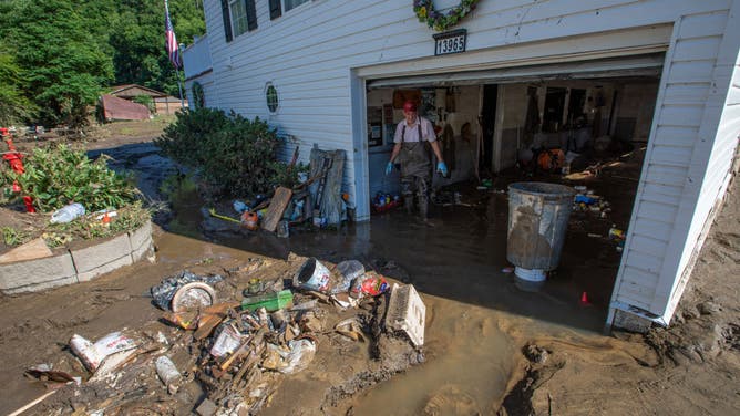 Man cleaning mud and debris from his garage