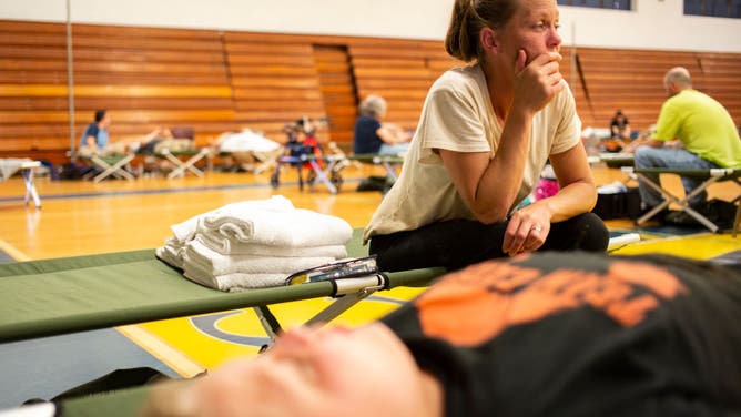 April Stivers, 38, of Lost Creek, Kentucky, takes a moment to herself in the Hazard Community &amp; Technical College, where survivors of the major flooding in Eastern Kentucky are being taken for shelter on July 28, 2022 in Breathitt County, Kentucky.