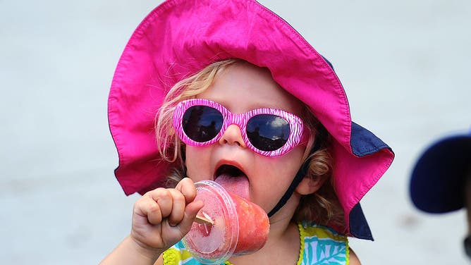 Keeping cool with a popcicle is 2-year-old Avery Pausner at The 20th annual Taste of the Danforth festival. 