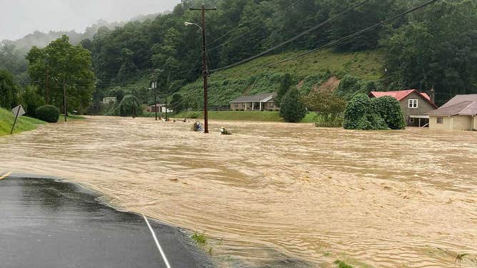 'Houses are floating away': Families trapped as floodwaters tear ...