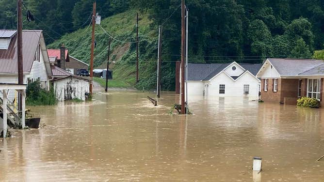 'Houses are floating away': Families trapped as floodwaters tear ...