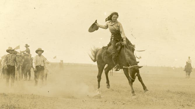Louise Topson hangs onto her horse