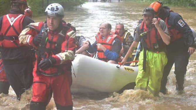 A water rescue team in Pound, Virginia helps people through flood waters.