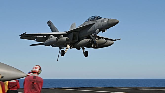 FA 18 Super Hornet jet landing on the USS Harry S Truman