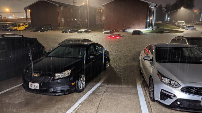 Flood waters cover cars in a St. Charles, Missouri parking lot from record rainfall on July 26, 2022