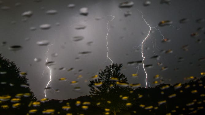 FILE - Lightning strikes over Lake Fairfax Park as bands of thunderstorms move through the DC area on Tuesday, May 15, 2018, in Reston, VA.