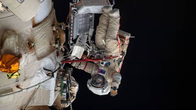 Cosmonaut Oleg Artemyev waves to the camera while working outside the Nauka multipurpose laboratory module during a spacewalk on April 18, 2022, that lasted for six hours and 37 minutes to outfit Nauka and configure the European robotic arm on the International Space Station's Russian segment.