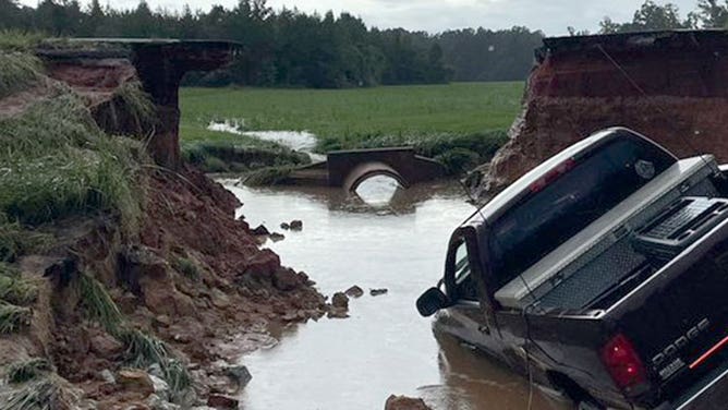 Truck in ravine after road washed away in Mississippi floods