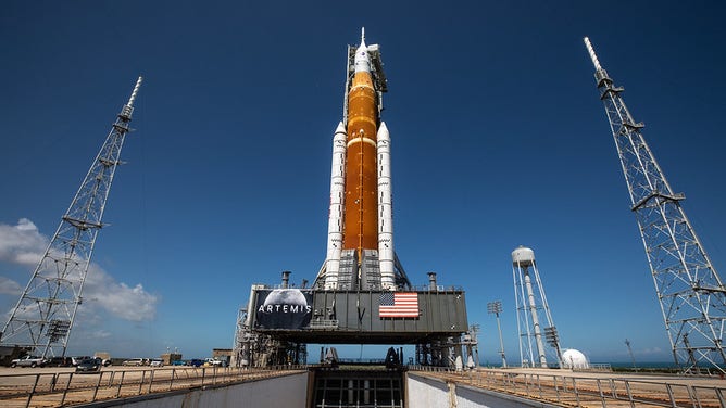 Andrew McCarthy's image of the moon hangs on the banner underneath of NASA’s Space Launch System (SLS) rocket and Orion spacecraft atop the mobile launcher at the agency’s Kennedy Space Center in Florida on March 18, 2022.