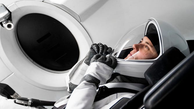 Cosmonaut Anna Kikina sits in a mockup of the spacecraft that will take NASA's SpaceX Crew-5 mission to the International Space Station during a training at SpaceX in Hawthorne, California.