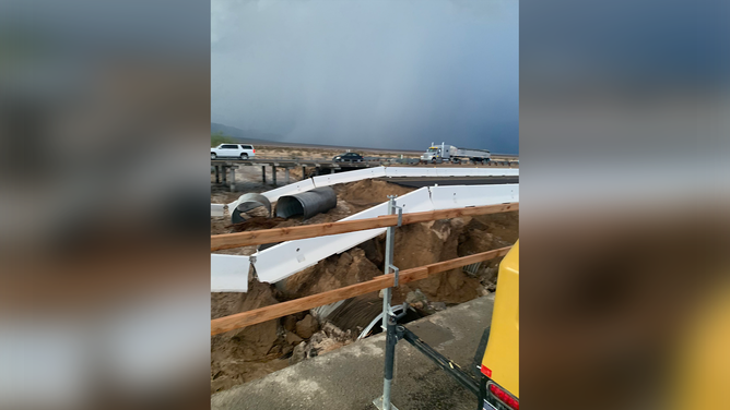 Barriers are seen dangling over the edge after flash flooding washed away part of the I-10 freeway near the California-Arizona border.