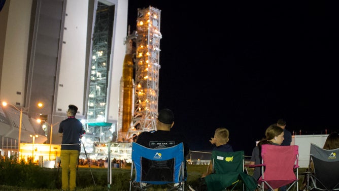 Spectators watch as NASA's Space Launch System rocket and Orion spacecraft make the journey to Kennedy Space Center launchpad 39B on Aug. 16, 2022.