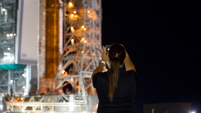 Spectators watch as NASA's Space Launch System rocket and Orion spacecraft make the journey to Kennedy Space Center launchpad 39B on Aug. 16, 2022.