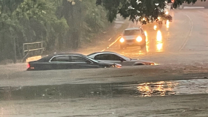 Cars are seen submerged in floodwaters in Dallas on Monday, Aug. 22, 2022.