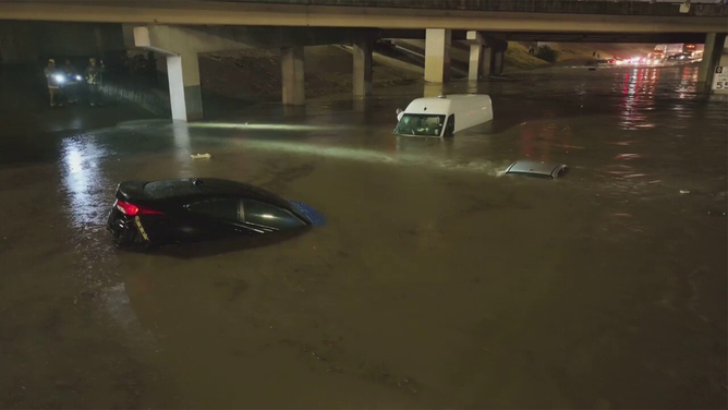 Vehicles are seen submerged in floodwaters in Dallas early Monday morning