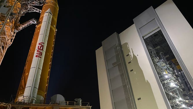 NASA's SLS rocket and Orion spacecraft are seen leaving the Vehicle Assembly Building for the last time before launch.