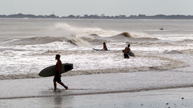 Surfer work the waves on Folly Beach, South Carolina.