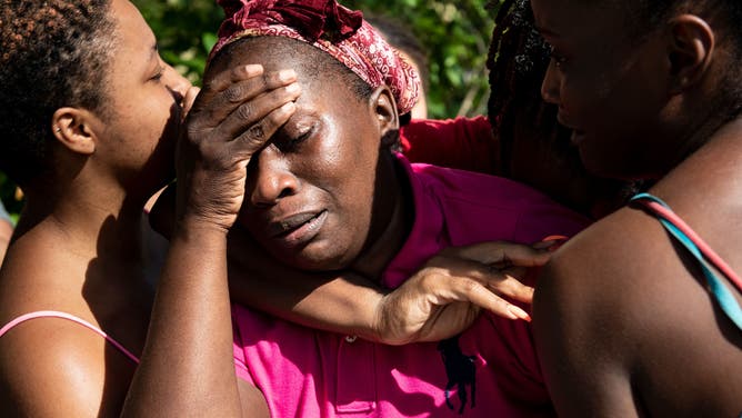 Catherine Russel is greeted by loved ones after arriving with other survivors of Hurricane Dorian from Abaco island on Sept. 4, 2019.