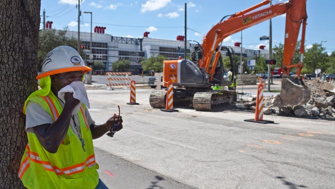 Construction worker Chester Gibson wipes sweat from his face on a hot day August 4, 2011 Houston, Texas.