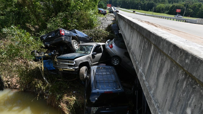 A cluster of trucks and other vehicles, washed into a bridge by floodwaters in Waverly, TN.