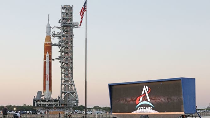 The massive Artemis I rocket rolls past the countdown clock atop a mobile launch platform en route to Launch Pad 39B from the Vehicle Assembly Building at the Kennedy Space Center in Florida March 17, 2022.